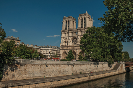 People, tree-lined Seine River and gothic Notre-Dame Cathedral at Paris. Known as theの写真素材