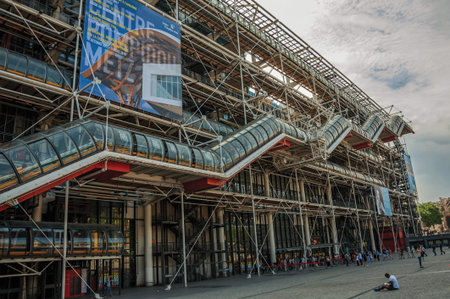 Paris, northern France - July 09, 2017. Facade and escalator of the Georges Pompidou Center in cloudy day at Paris. Known as the "City of Light", it is one of the most impressive cultural centers in the world.のeditorial素材