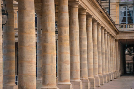 Pathway with marble colonnade between courtyards and cloudy sky at the Palais-Royal in Paris. Known as the "City of Light", it is one of the most impressive cultural centers in the world. Northern France.のeditorial素材