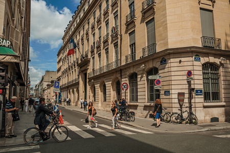 Paris, France - July 11, 2017. Buildings and people walking down the street in sunny day at Paris. Known as the "City of Light", it is one of the most impressive cultural centers in the world. Northern France.のeditorial素材