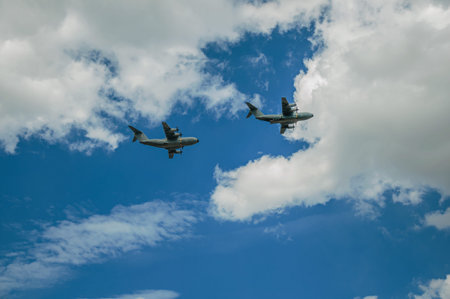 Close-up of military aircraft passing through the overcast sky of Paris. Known as the City of Light,...