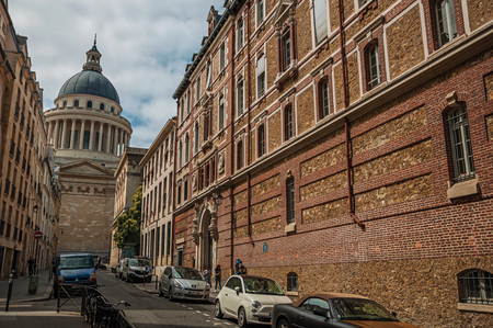 Paris, northern France - July 12, 2017. Street with brick buildings and Pantheon dome in the background at Paris. Known as the "City of Light", it is one of the most impressive cultural centers in the world.のeditorial素材
