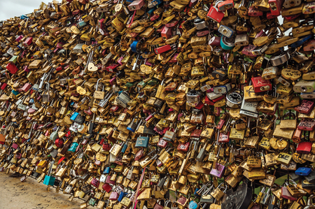 Paris, northern France - July 12, 2017. Padlocks fastened to each other celebrating love on bridge balustrade at Seine River in Paris. Known as one of the world's most impressive cultural centers.のeditorial素材