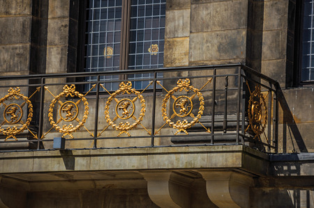 Close-up of facade with balcony and golden iron balustrade in the Royal Palace of Amsterdam. The city is famous for its huge cultural activity, graceful canals and bridges. Northern Netherlands.のeditorial素材