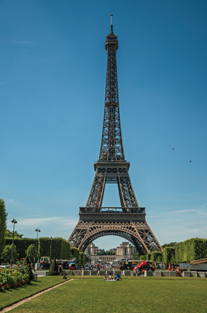 Paris, France - July 07, 2017. People, greenery and Eiffel Tower with sunny blue sky in Paris. Known as the "City of Light", it is one of the world's most awesome cultural centers. Northern France.のeditorial素材