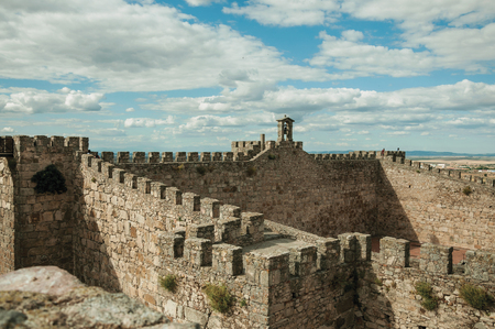 Pathway on top of thick stone wall with crenel, merlons and bell at the Castle of Trujillo. A small medieval town, birthplace of the Conquistador Francisco Pizarro in western Spain.のeditorial素材
