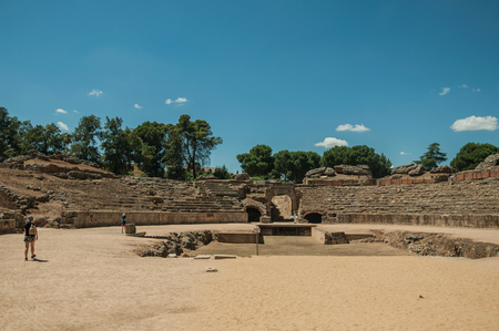 Merida, Spain - July 05, 2018. People walking around the arena of Roman Amphitheater in a sunny day at Merida. Founded by ancient Rome in western Spain, the city preserves many buildings of that era.の写真素材