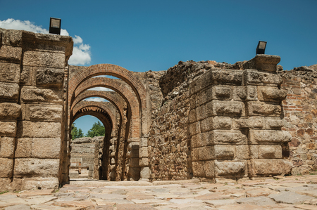 Exit gateway with arches of Roman Amphitheater in a sunny day, at the huge archaeological site of Merida. Founded by ancient Rome in western Spain, the city preserves many buildings of that era.の写真素材