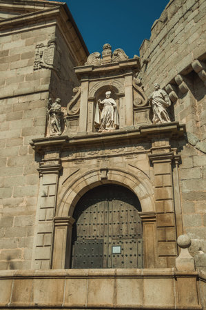 Gateway decorated with sculptures and carved stone on top of staircase in a clerical building at...