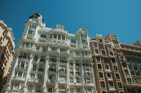 Facade with flamboyant decoration on old buildings full of windows, in a sunny day at Madrid. Capital of Spain this charming metropolis has vibrant and intense cultural life.のeditorial素材