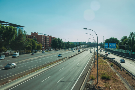 Madrid, Spain - July 25, 2018. Cars on highway with heavy traffic at business district, on sunset in Madrid. Capital of Spain this charming metropolis has vibrant and intense cultural life.のeditorial素材