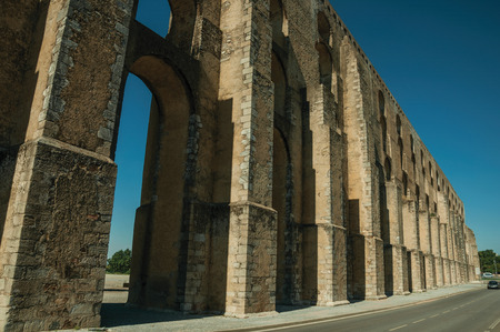 Architectural structure of the Amoreira Aqueduct with arches and rectangular pillars on the road to Elvas. A gracious star-shaped fortress city on the easternmost frontier of Portugal.の写真素材