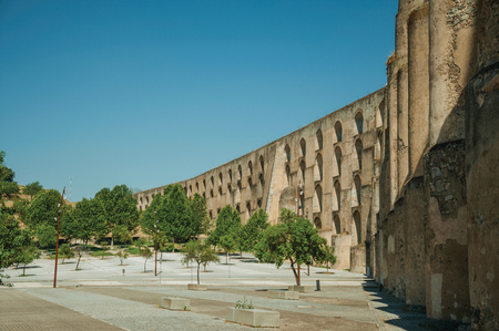 Amoreira Aqueduct with arches and rectangular pillars in front of wooden square at the western entrance of Elvas. A gracious star-shaped fortress city on the easternmost frontier of Portugal.の写真素材