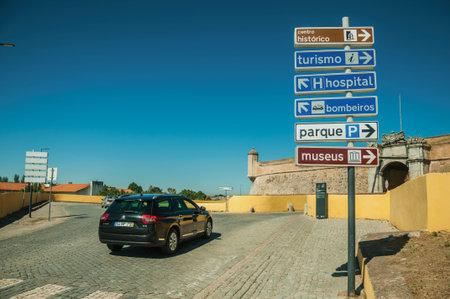 Elvas, Portugal - July 07, 2018. Car in street with signpost indicating public services and city...