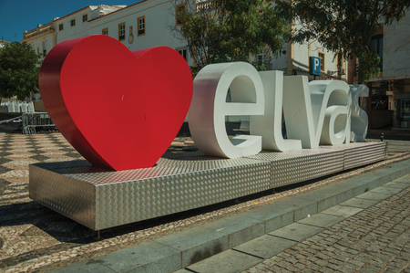 Elvas, Portugal - July 07, 2018. Large signpost with the city name in a sunny square of Elvas. A gracious star-shaped fortress city on the easternmost frontier of Portugal.のeditorial素材