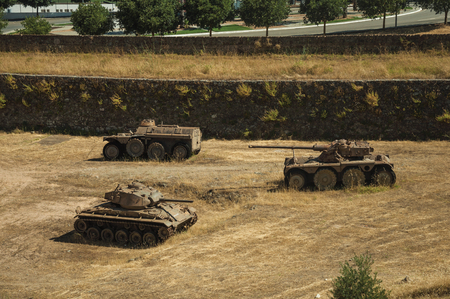 Elvas, Portugal - July 07, 2018. Outdated war tanks next to the wall that encircle the city of Elvas. A gracious star-shaped fortress city on the easternmost frontier of Portugal.のeditorial素材