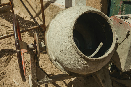 Close-up of old cement mixer and sand in a construction site of a shabby house at Castelo de Vide. Nice little town with medieval castle to ensure the defense of the Portugal eastern border.の写真素材