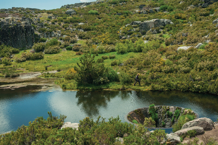 Large sinkhole constructed as a water spillway at the Covao dos Conchos dam lake on the highlands of the Serra da Estrela. The highest mountain range in continental Portugal, with astonishing scenery.の写真素材