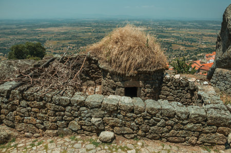 Stone fences and small hut formerly used for pig farming in a sunny day, with countryside landscape at Monsanto. Considered one of the cutest and most peculiar historic village of Portugal.の写真素材