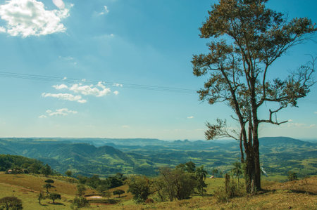 Pardinho, Brazil - View of meadows and trees in a green valley with mountainous landscape, in a...