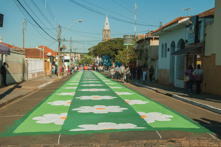 Sao Manuel, Brazil - May 31, 2018. Artistic colorful sand carpet made by the devotees for the celebration of Holy Week on the street of Sao Manuel. A little town in the countryside of Sao Paulo State.のeditorial素材
