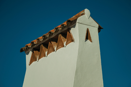 Large chimney covered by rough plaster and rooftop in a sunny day at Marvao. An amazing medieval fortified village perched on a granite crag in eastern Portugal.の写真素材