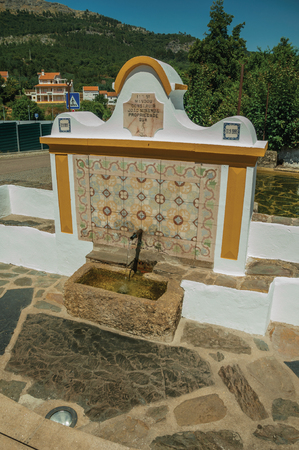 Marvao, Portugal - Fountain with water spout made with ceramic tiles in Portagem. A district of MarvÃ£o at the bottom of a lush wooded valley in eastern Portugal.の写真素材