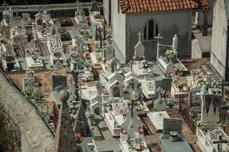 Gouveia, Portugal - July 17, 2018. Cemetery with crypts and marble tombs decorated by flowers at Gouveia. A nice country town with gardens and captivating historical heritage in Portugal.の写真素材