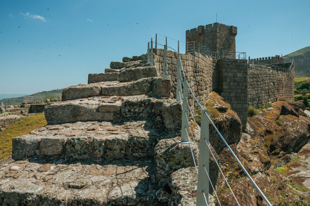 Path with steps over stone wall with balustrade and hilly landscape at the Linhares da Beira Castle. A medieval hamlet with unique architectural diversity fruit of several times, in eastern Portugal.のeditorial素材