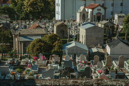 Guarda, Portugal - July 21, 2018. Cemetery with crypts and marble tombs decorated by flowers at Guarda. This friendly and well-kept medieval town is the highest in the continental Portugal.のeditorial素材