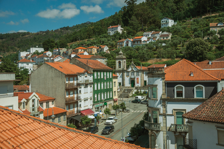 Seia, Portugal - July 19, 2018. Street with colorful buildings and baroque church in a hilly landscape at Seia. This friendly town in eastern Portugal is also known for its delicious artisanal cheeseのeditorial素材