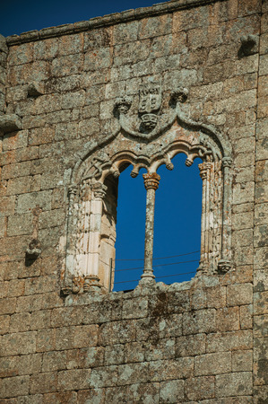 Decorated window in gothic style on a wall made of stone bricks, in a sunny day at the medieval Belmonte Castle. A small town, birthplace of the navigator Pedro Alvares Cabral, on eastern Portugal.のeditorial素材