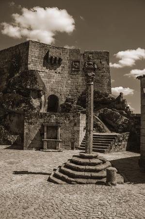 Stone Castle facade with staircase on square and pillory, in a sunny day at Sortelha. One of the most astonishing and well preserved medieval villages in all Portugal. Black and white photo.のeditorial素材