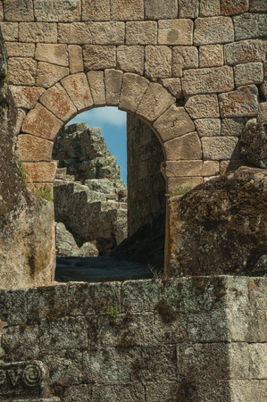 Castle facade over rocky hill with open gateway on stone wall, in a sunny day at Sortelha. One of the most astonishing and well preserved medieval villages in all Portugal.のeditorial素材