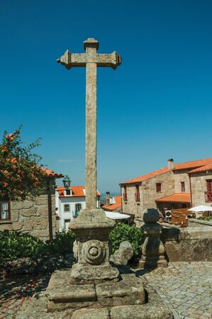 Cross shape pillory made of stone in courtyard and old houses, in a sunny day at Linhares da Beira. A medieval hamlet with unique architectural diversity fruit of several times, in eastern Portugal.の写真素材