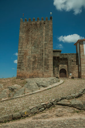 Stone walls and square tower over rocky hill in a sunny day, at the front facade of medieval Belmonte Castle. A small town, birthplace of the navigator Pedro Alvares Cabral, on eastern Portugal.のeditorial素材