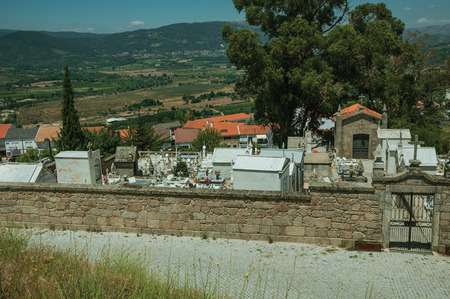 Guarda, Portugal - July 16, 2018. Cemetery with walls and iron gate encircling tombs and crypts in Belmonte. A cute small town, birthplace of the navigator Pedro Alvares Cabral, on eastern Portugal.のeditorial素材