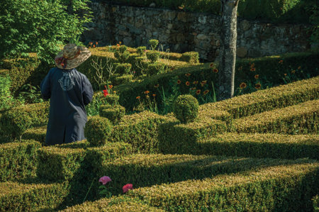 Marvao, Portugal - July 09, 2018. Municipal employee responsible for gardening a lush yard in front the Castle of Marvao. An amazing medieval fortified village perched on a crag in eastern Portugal.のeditorial素材