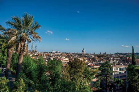 Overview of trees, cathedrals domes and roofs of buildings in the sunset of Rome, the incredible city of the Ancient Era, known asの写真素材