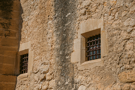 Close-up of the Lourmarin Castle walls and windows with bars, near the village of Lourmarin. In the Vaucluse department, Provence-Alpes-Cote d Azur region, southeastern Franceのeditorial素材