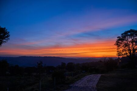 Multicolored clouds and sky at sunset dusk forming an amazing landscape in a farmstead near Bento Goncalves. A friendly country town in southern Brazil famous for its wine production.の写真素材