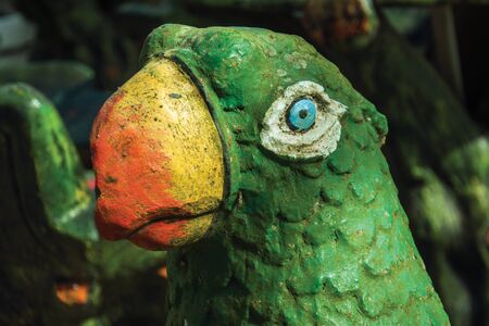 Decorative sculpture of colorful parrot in a rustic furniture store near Bento Goncalves. A friendly country town in southern Brazil famous for its wine production.の写真素材
