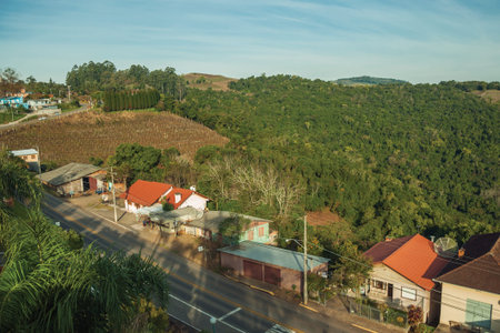 Roadside houses on a small countrified village in a hilly region covered by forests near Bento Goncalves. A friendly country town in southern Brazil famous for its wine production.の写真素材