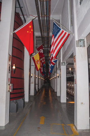 Corridor with tanks for wine storage and flags from several countries at the Aurora Winery facilities in Bento Goncalves. A friendly country town in southern Brazil famous for its wine production.の写真素材