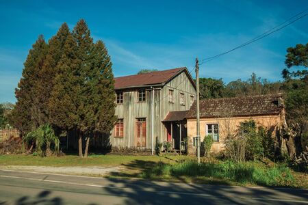 Old wooden and masonry houses in a traditional rural style with lawn and trees near Bento Goncalves. A friendly country town in southern Brazil famous for its wine production.の写真素材