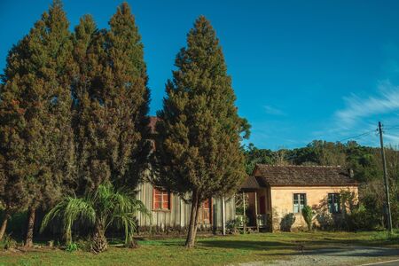 Old wooden and masonry houses in a traditional rural style with lawn and trees near Bento Goncalves. A friendly country town in southern Brazil famous for its wine production.の写真素材