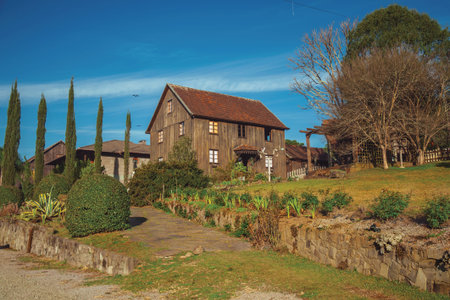 Wooden old house in a traditional rural style with garden on top of small hill near Bento Goncalves. A friendly country town in southern Brazil famous for its wine production.の写真素材