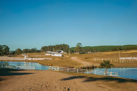 Landscape of charming ranch with wooden sheds and fences in rural lowlands called Pampas near Cambara do Sul. A small country town in southern Brazil with amazing natural tourist attractions.の写真素材