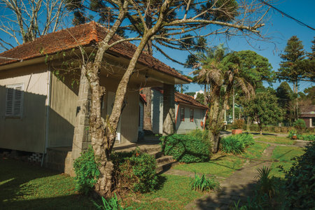 Rustic housing development amid trees and green garden in a sunny day at Gramado. A cute european-influenced town in southern Brazil highly sought after by tourists.の写真素材