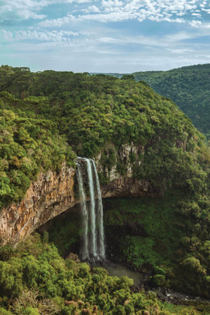 Detail of Caracol waterfall falling from rocky cliff in a canyon covered by forest from a park near Canela. A charming small town very popular by its ecotourism in southern Brazil.の写真素材
